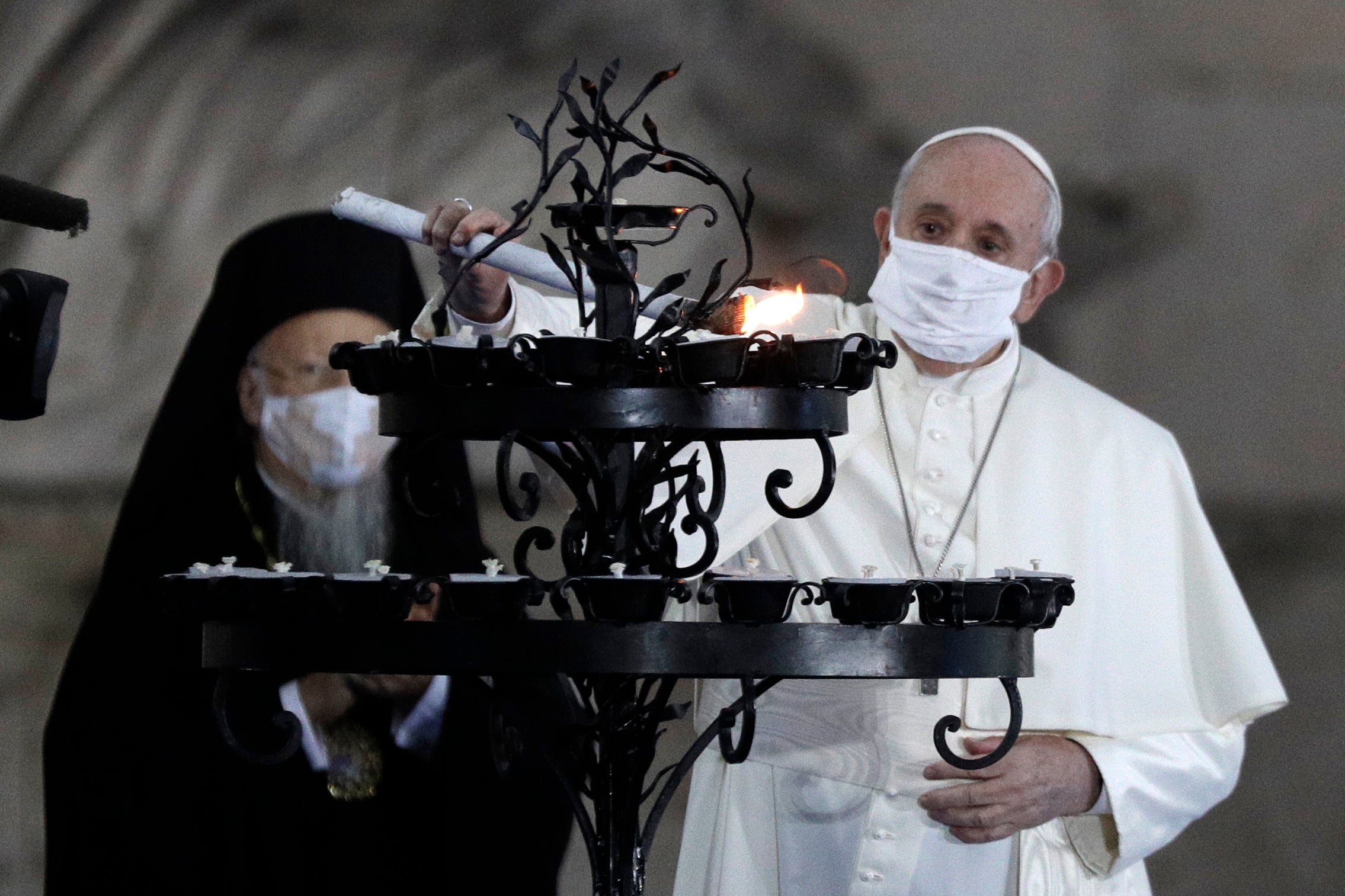 The Pope lights a candle for peace with other religious leaders