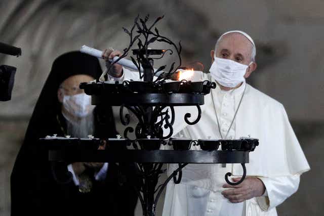 <p>The Pope lights a candle for peace with other religious leaders</p>