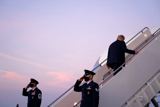President Donald Trump boards Air Force One to travel to a campaign rally in Erie, Pennsylvania, amid a new row with "60 Minutes." (AP Photo/Evan Vucci)