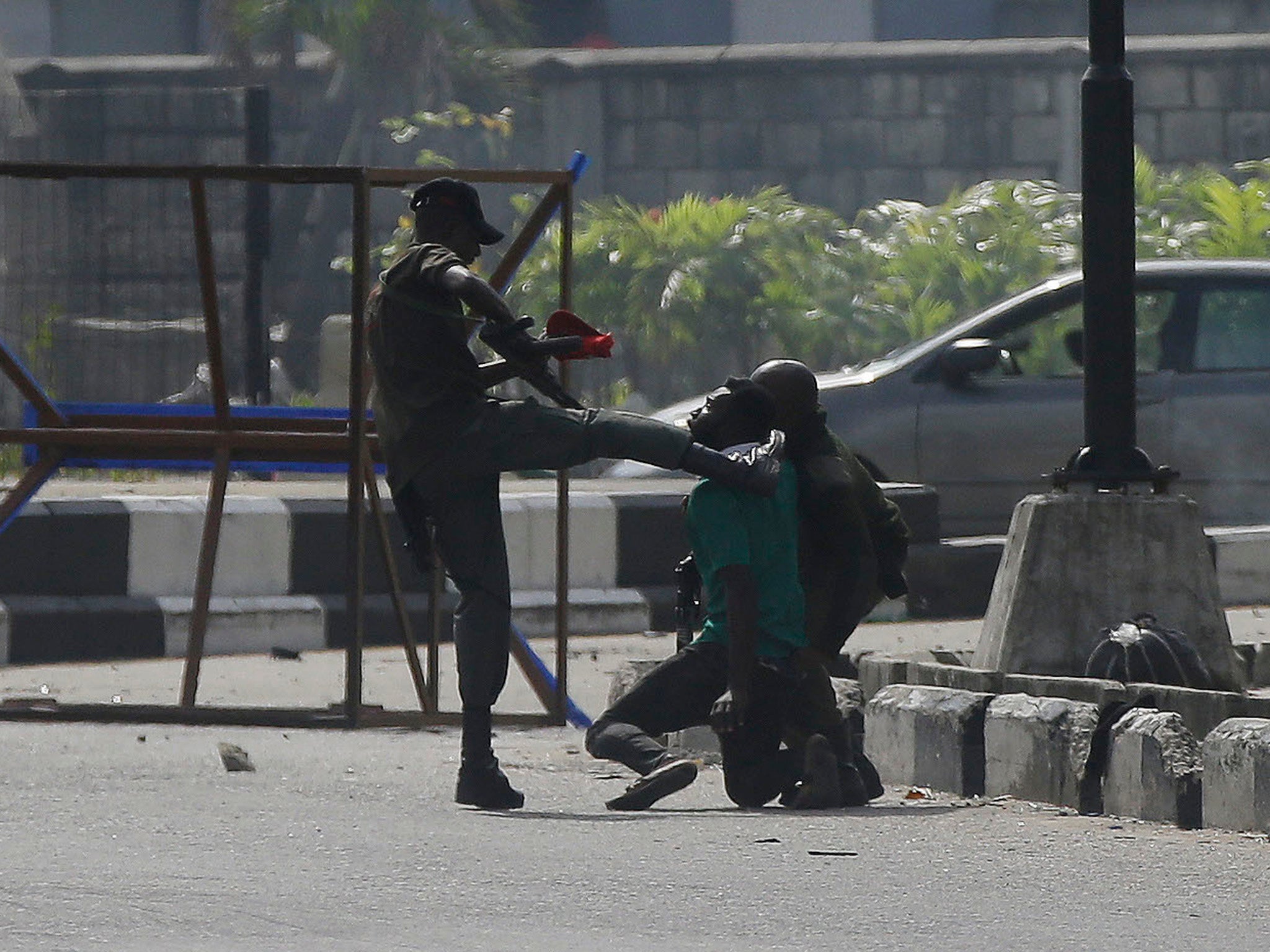 A police officer kicks a protester detained in Lagos on 21 October