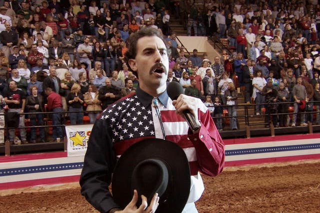 Very nice: Sacha Baron Cohen incites the fury of a crowd as he mangles the US anthem while singing at a rodeo