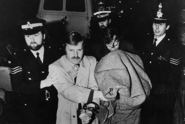 Peter Sutcliffe, aka The Yorkshire Ripper, is brought into Dewsbury Court under a blanket