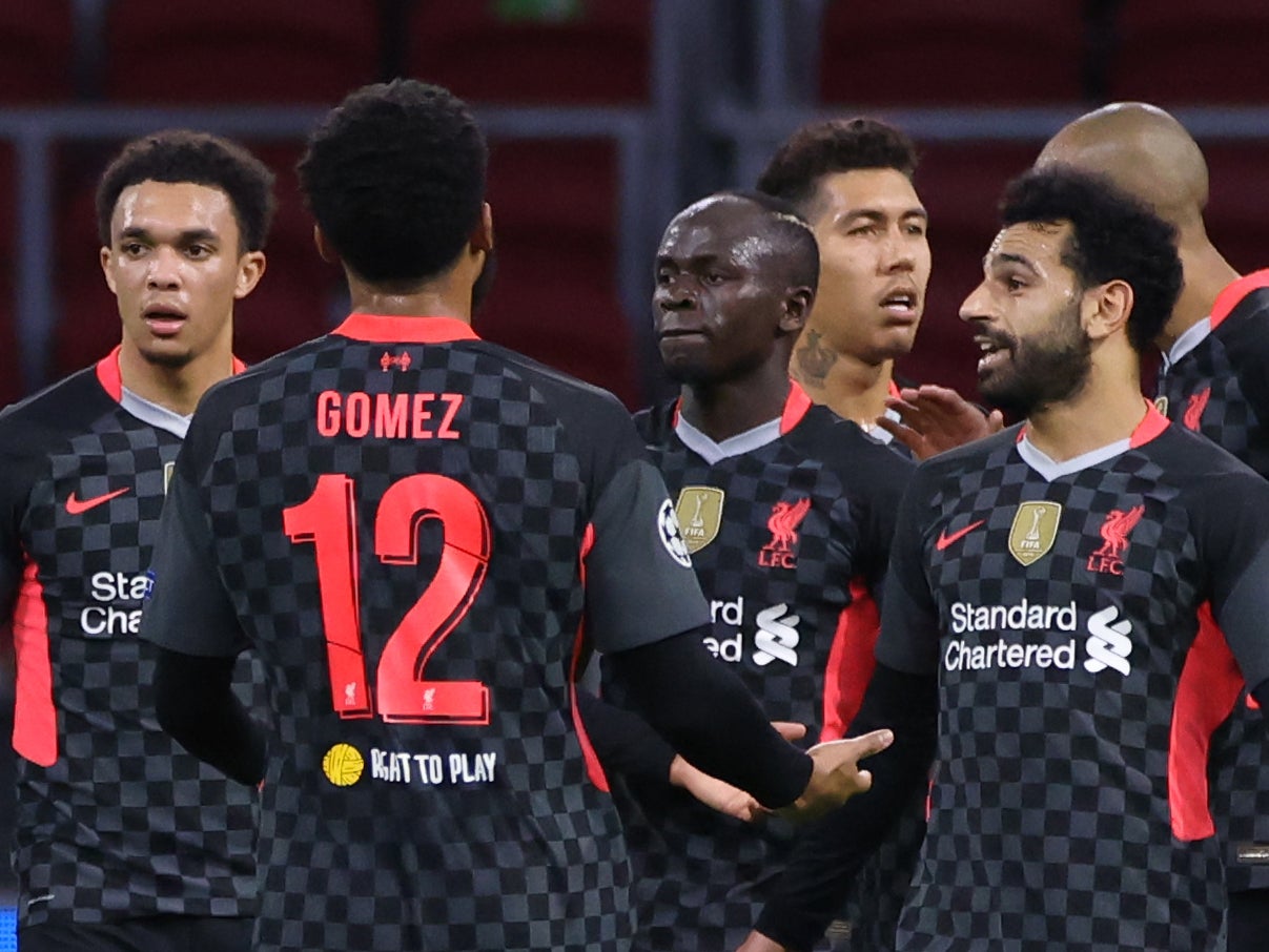 Liverpool players celebrate after Ajax scored an own goal