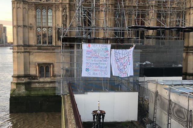 Banners displayed by activist on Big Ben’s scaffolding, photographed by a passerby