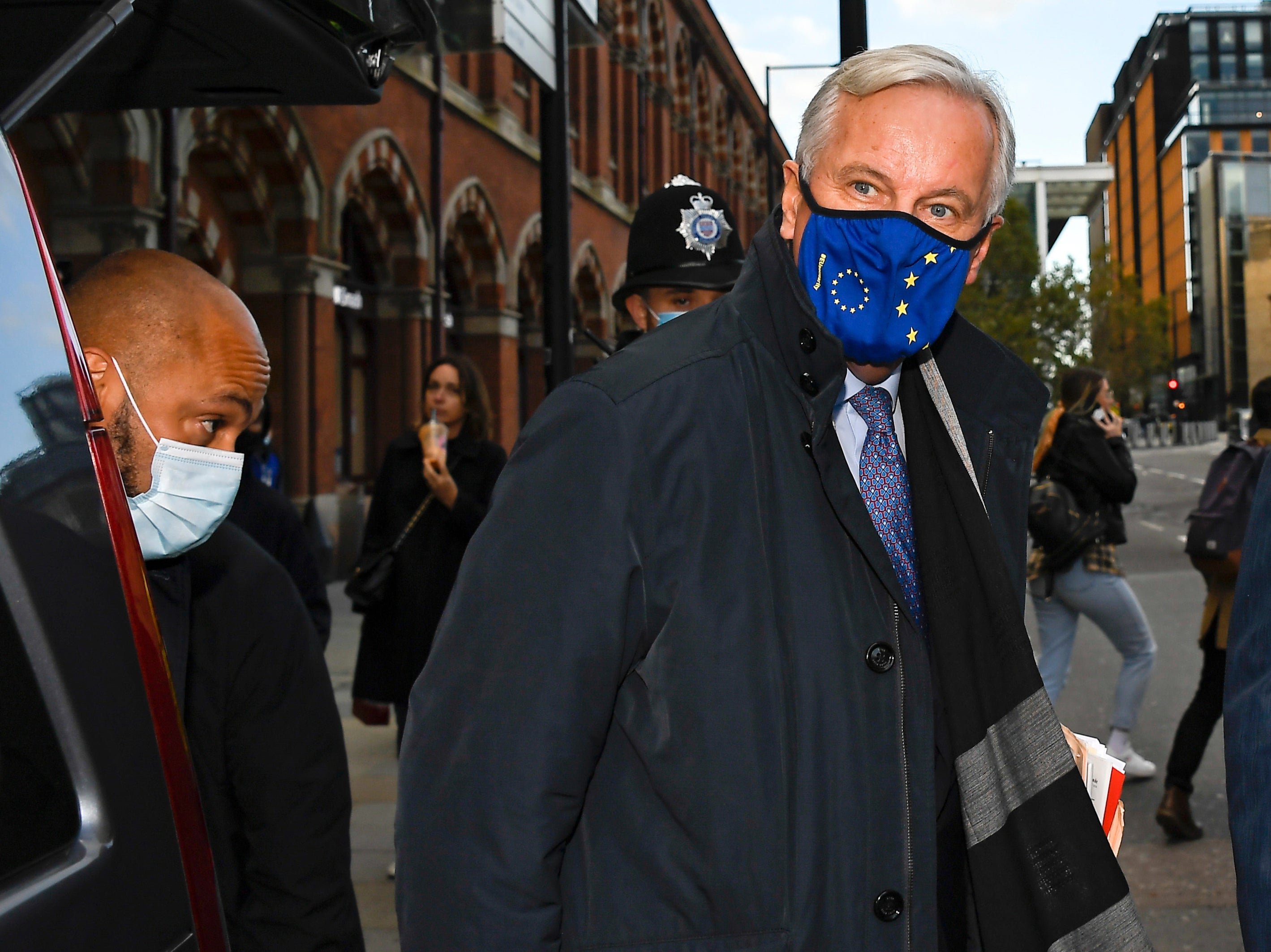 EU Chief negotiator Michel Barnier wears a face mask as he arrives at St Pancras station