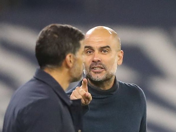 Pep Guardiola gestures as he exchanges words with Sergio Conceicao