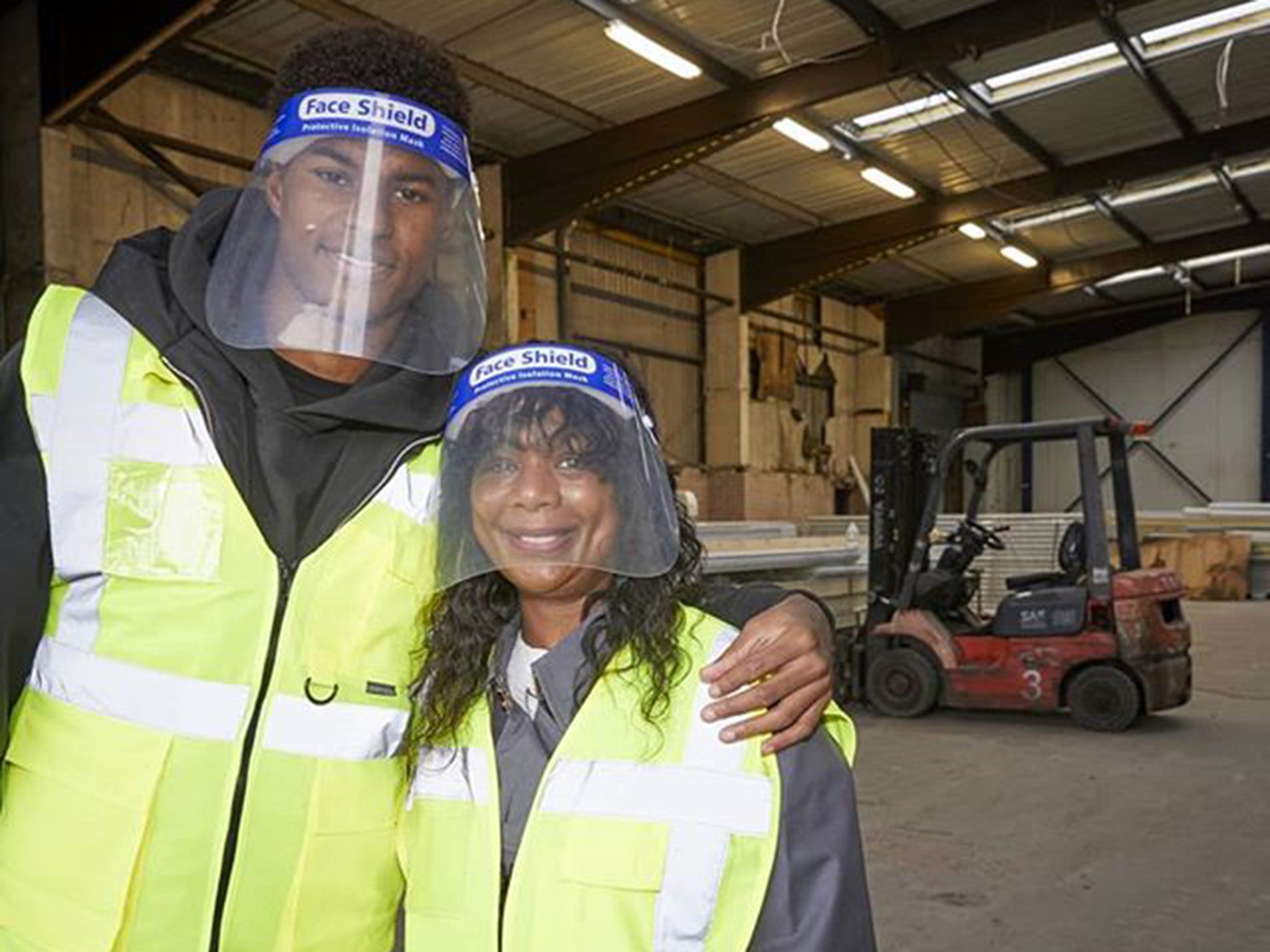 Marcus Rashford with his mother Melanie at a food bank in Manchester