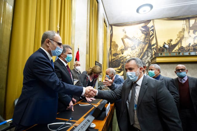Participants of the fourth round of the 5+5 Libyan Joint Military Commissionsign shaking hands after signing an Agreement for a Complete and Permanent Ceasefire in Libya, at United Nation’s Palais des Nations in Geneva, Switzerland, 23 October 2020. According to the United Nations (UN), the two rival sides in the Libyan civil war have agreed on a nationwide ceasefire.  (EPA/Violaine Martin / UN)
