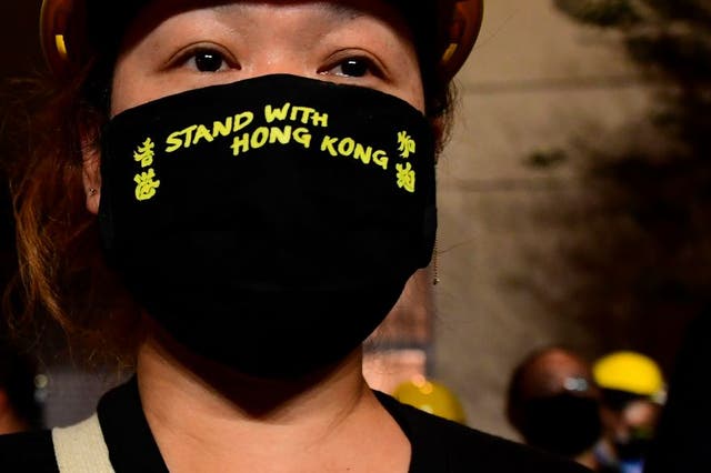 An activist in front of the Chinese Consulate in Los Angeles, in October, in protest of the Chinese government’s treatment of Hong Kong