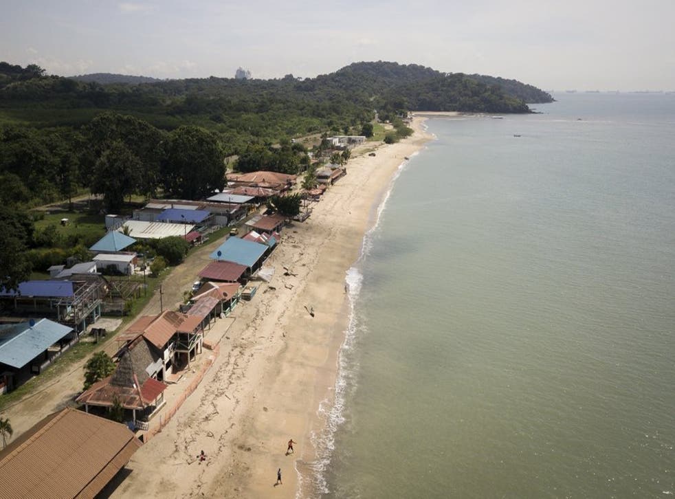 La gente camina por la costa un día antes de que las playas vuelvan a abrir oficialmente después de meses de bloqueo para contener la propagación del COVID-19, en Veracruz, en las afueras de la ciudad de Panamá, el viernes 23 de octubre de 2020. (Foto/Arnulfo Franco)