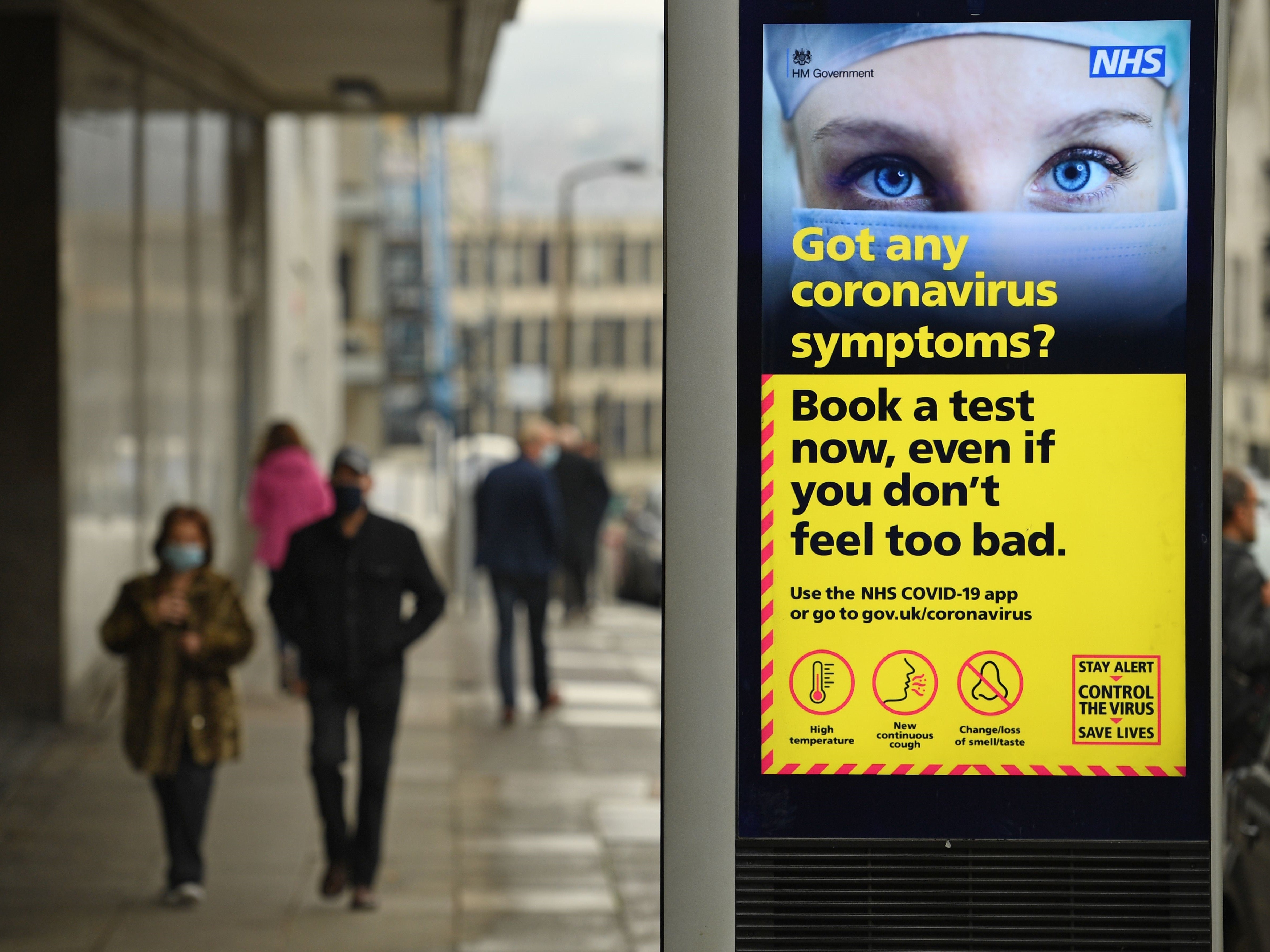 People walk past a display featuring health advice in Sheffield city centre