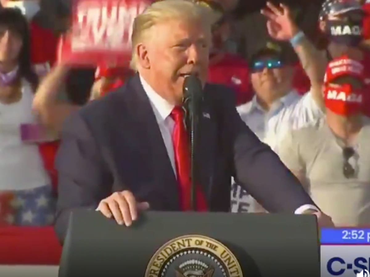 Trump supporter appears to repeatedly flash white power sign at Florida rally