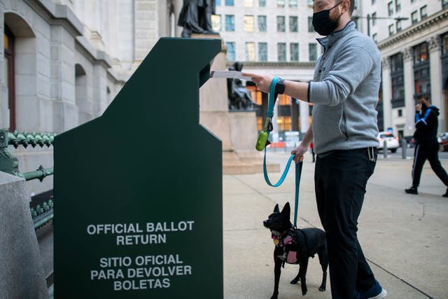  A voter casting his early voting ballot at drop box outside of City Hall on 17 October, 2020 in Philadelphia, Pennsylvania