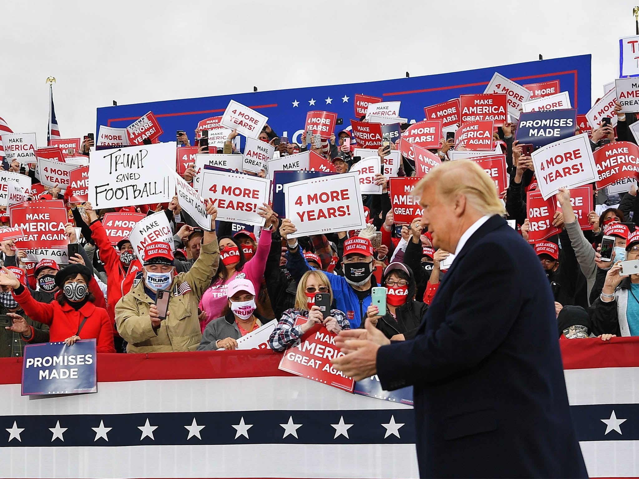 Supporters cheer as US President Donald Trump arrives to speak during a campaign rally at Pickaway Agriculture and Event Centre in Circleville, Ohio on 24 October, 2020