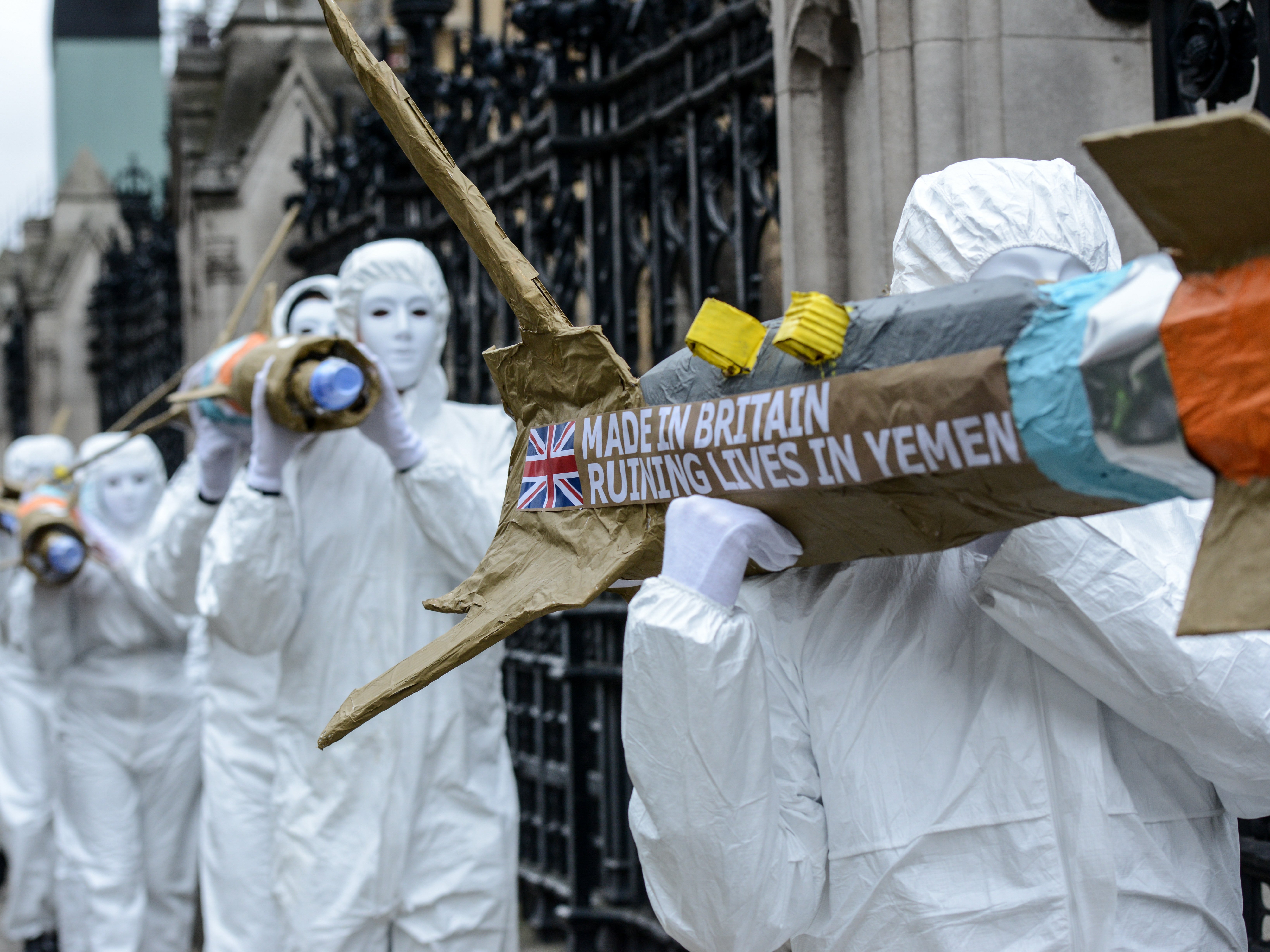 Amnesty International activists march with homemade replica missiles during a protest over UK arms sales to Saudi Arabia, 18 March 2016