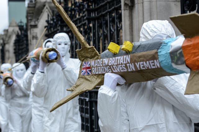 Amnesty International activists march with homemade replica missiles during a protest over UK arms sales to Saudi Arabia, 18 March 2016