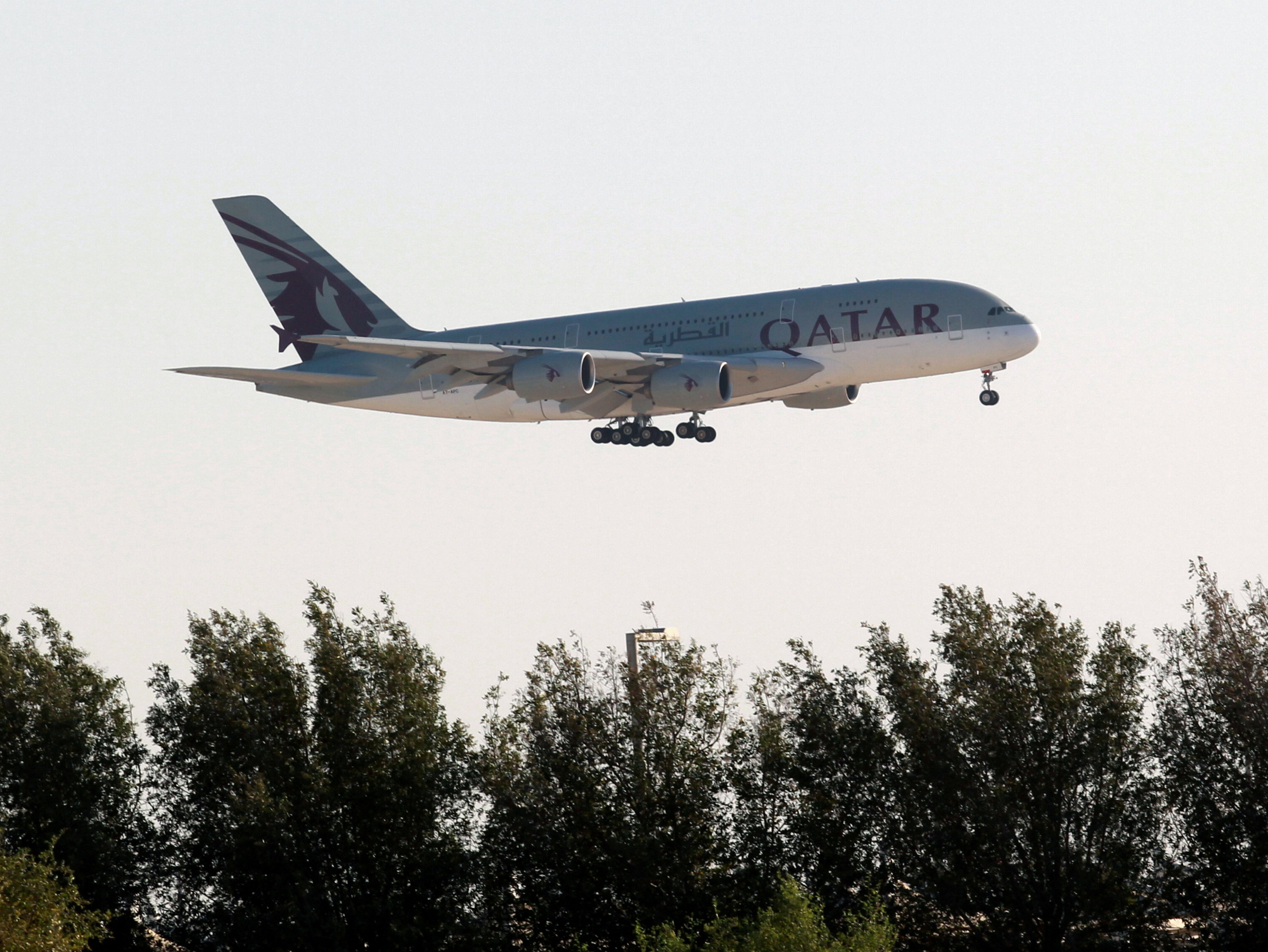 A Qatar Airways plane over Doha in Qatar