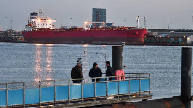 A television crew prepare to do a live transmission opposite the Nave Andromeda, an oil tanker berthed at Southampton docks, southwest England. British soldiers yesterday boarded the tanker and detained seven suspects, the defence ministry said, after the crew were forced to take shelter from stowaways who threatened them