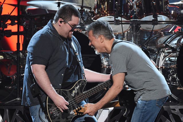 Bassist Wolfgang Van Halen (L) and guitarist Eddie Van Halen of Van Halen perform during the 2015 Billboard Music Awards