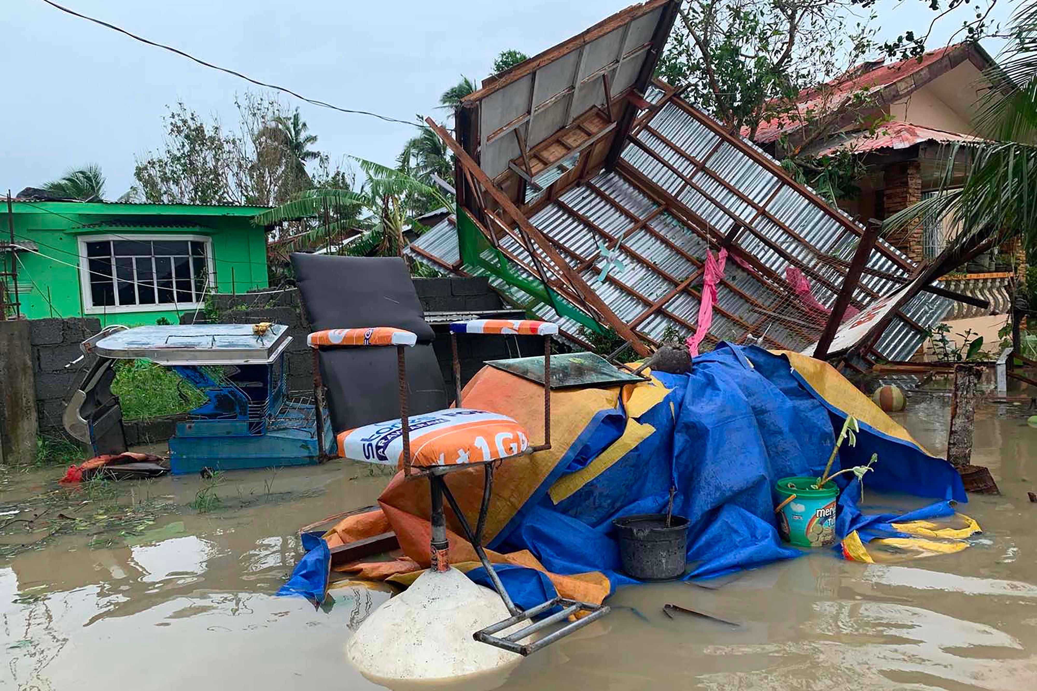 A destroyed house lies on its side after tropical storm Molave hit the town of Pola, Oriental Mindoro province