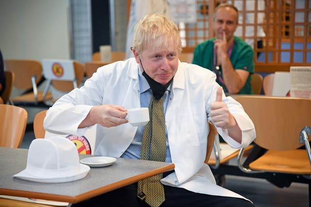 Boris Johnson visits a canteen in Reading earlier this week, as anger over free school meals intensifies