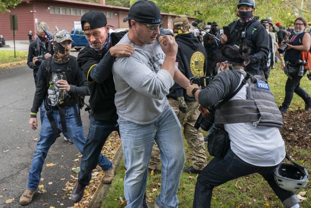 A member of the Proud Boys tackles a fellow member after he assaulted freelance journalist during a Proud Boy rally on September 26, 2020 in Portland, Oregon 