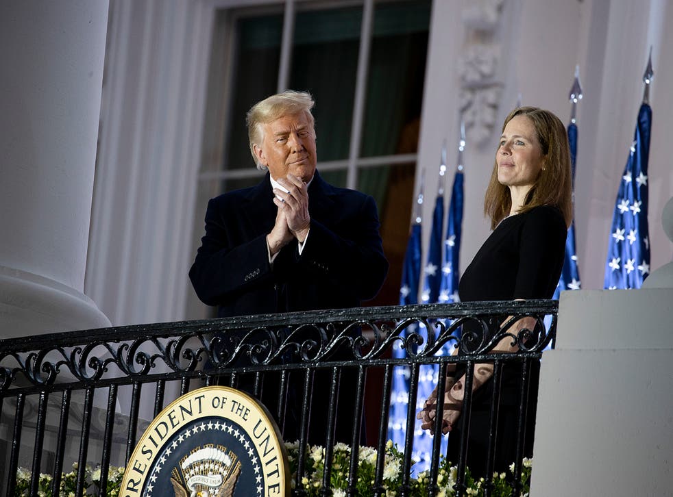 Trump stands with new US Supreme Court Justice Amy Coney Barrett during a ceremonial swearing-in event