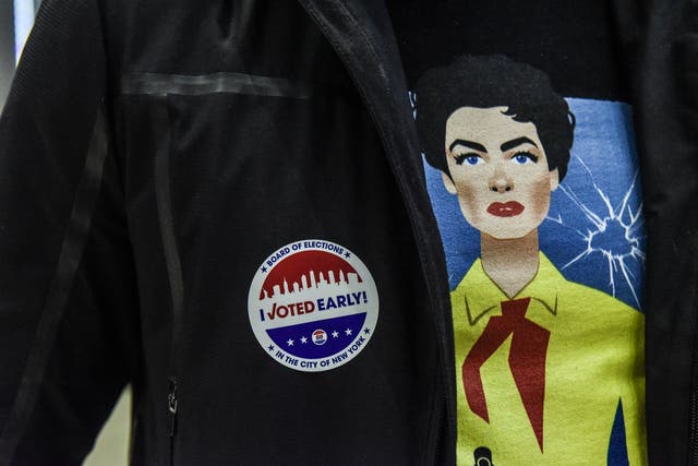 An early voter wears a sticker after casting a ballot at Madison Square Garden