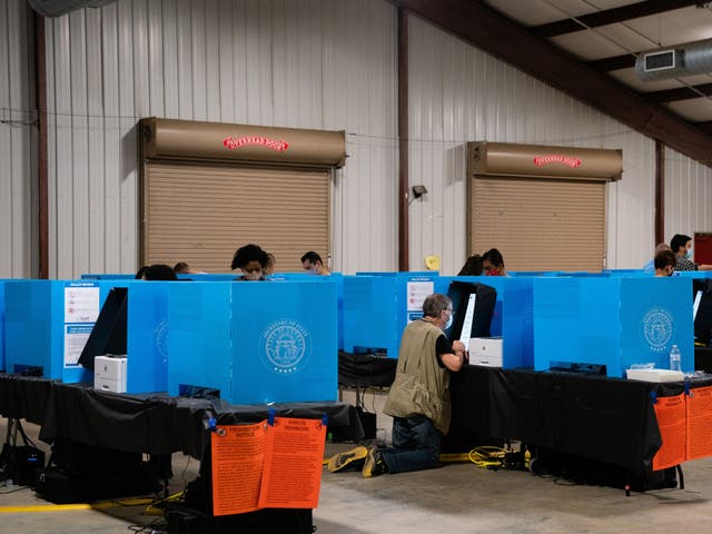People cast their ballots at an early voting location at the Gwinnett County Fairgrounds in Lawrenceville, Georgia