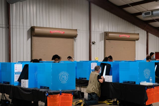 People cast their ballots at an early voting location at the Gwinnett County Fairgrounds in Lawrenceville, Georgia