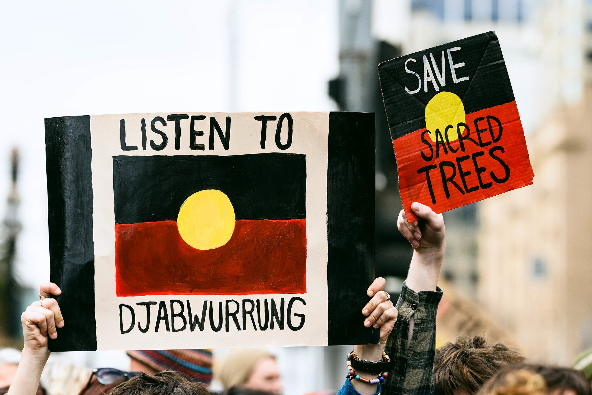 Djab Wurrung protesters hold placards up at Parliament House Canberra in September 2019