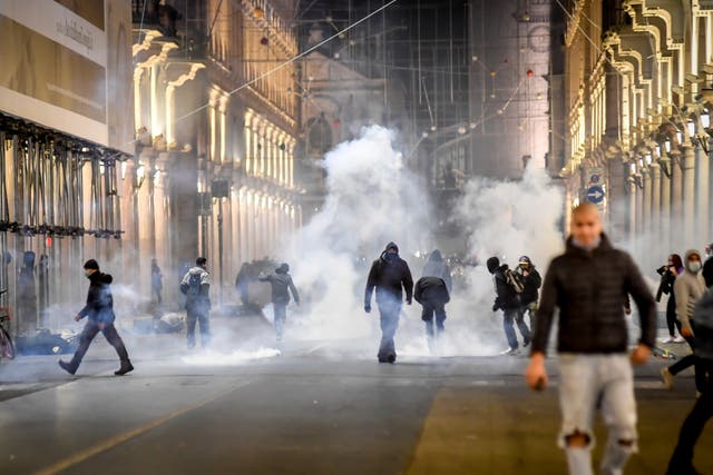 Smoke billows as clashes broke out during a protest against government restriction measures  in Turin