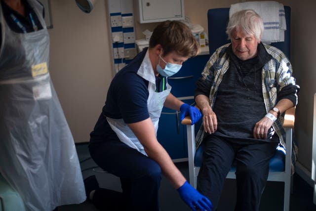 Rehab Support Workers perform a physiotherapy treatment on patient Michael Kidd, 82, at the NHS Seacole Centre at Headley Court, Surrey in May
