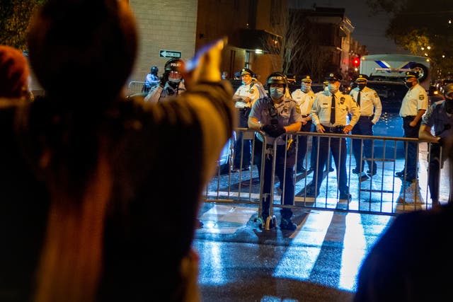 Neighbourhood residents shout at police outside the 18th District police station Monday night on 26 October 2020, in Philadelphia