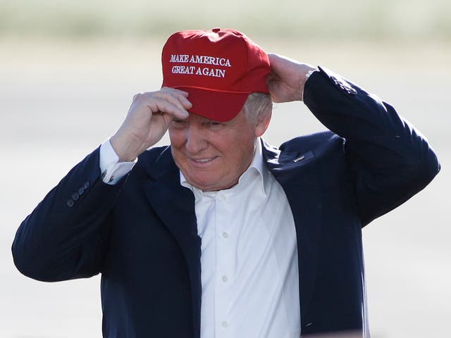  June 1, 2016, file photo, Republican presidential candidate Donald Trump wears his "Make America Great Again" hat at a rally in Sacramento, Calif.