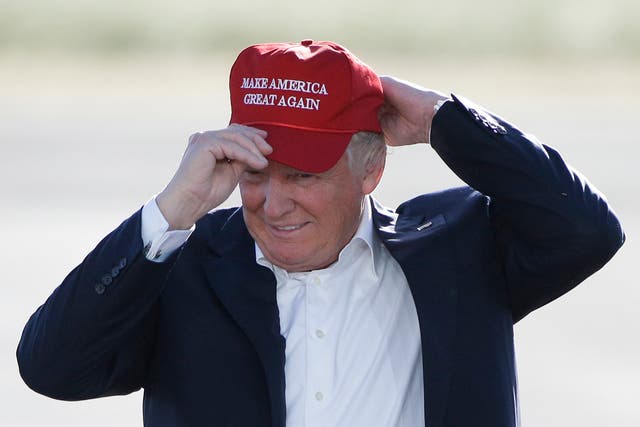  June 1, 2016, file photo, Republican presidential candidate Donald Trump wears his "Make America Great Again" hat at a rally in Sacramento, Calif.