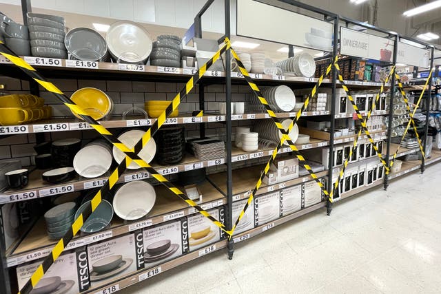 Kitchen products deemed ‘non-essential’ are seen covered up in a Cardiff Tesco store
