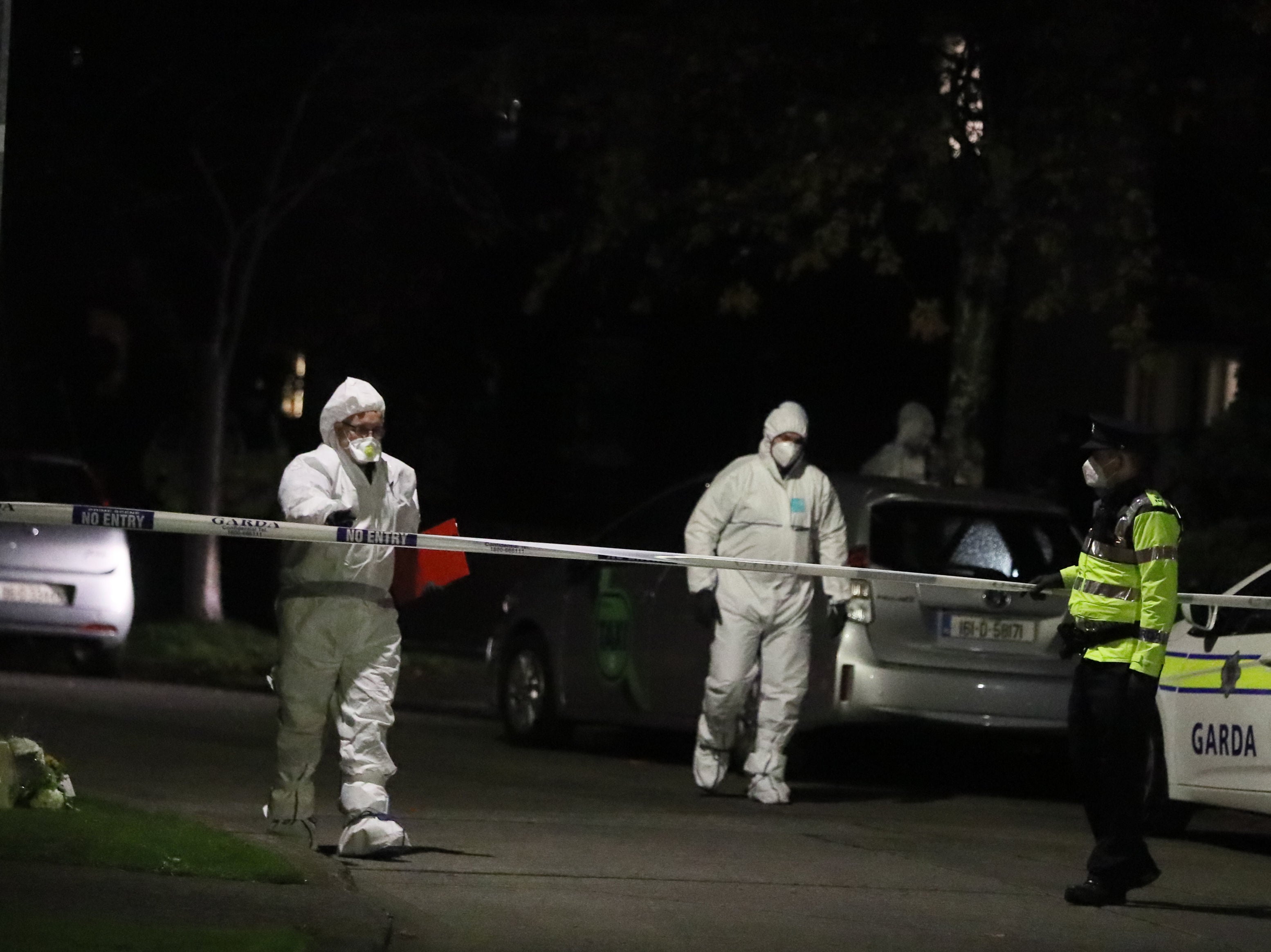 Forensic officers the scene in the Llewellyn estate in Ballinteer, south Dublin, following the discovery of bodies of a woman and two young children