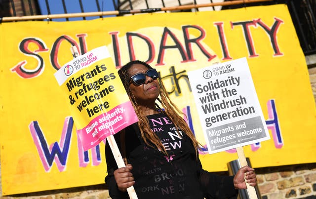 <p>A woman gathers for a Windrush generation solidarity protest in Brixton, 20 April, 2018</p>