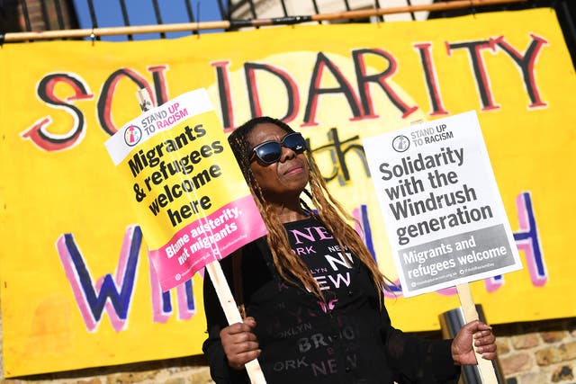<p>A woman gathers for a Windrush generation solidarity protest in Brixton, 20 April, 2018</p>