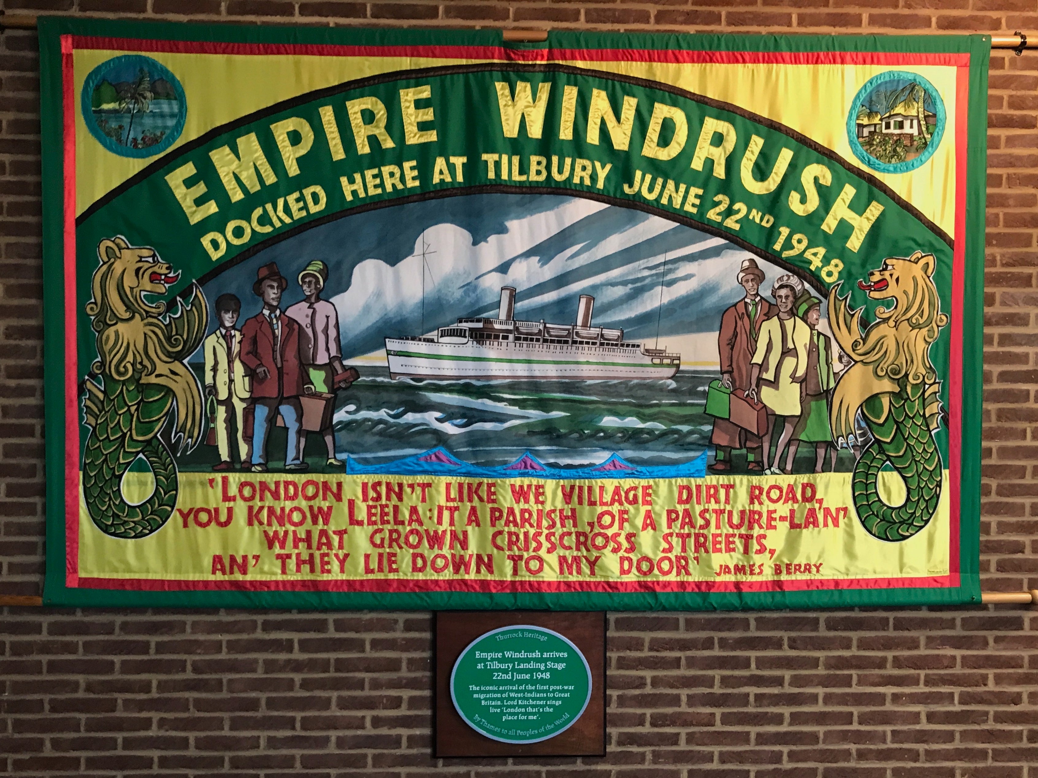 <p>A Windrush mural and plaque in Tilbury</p>