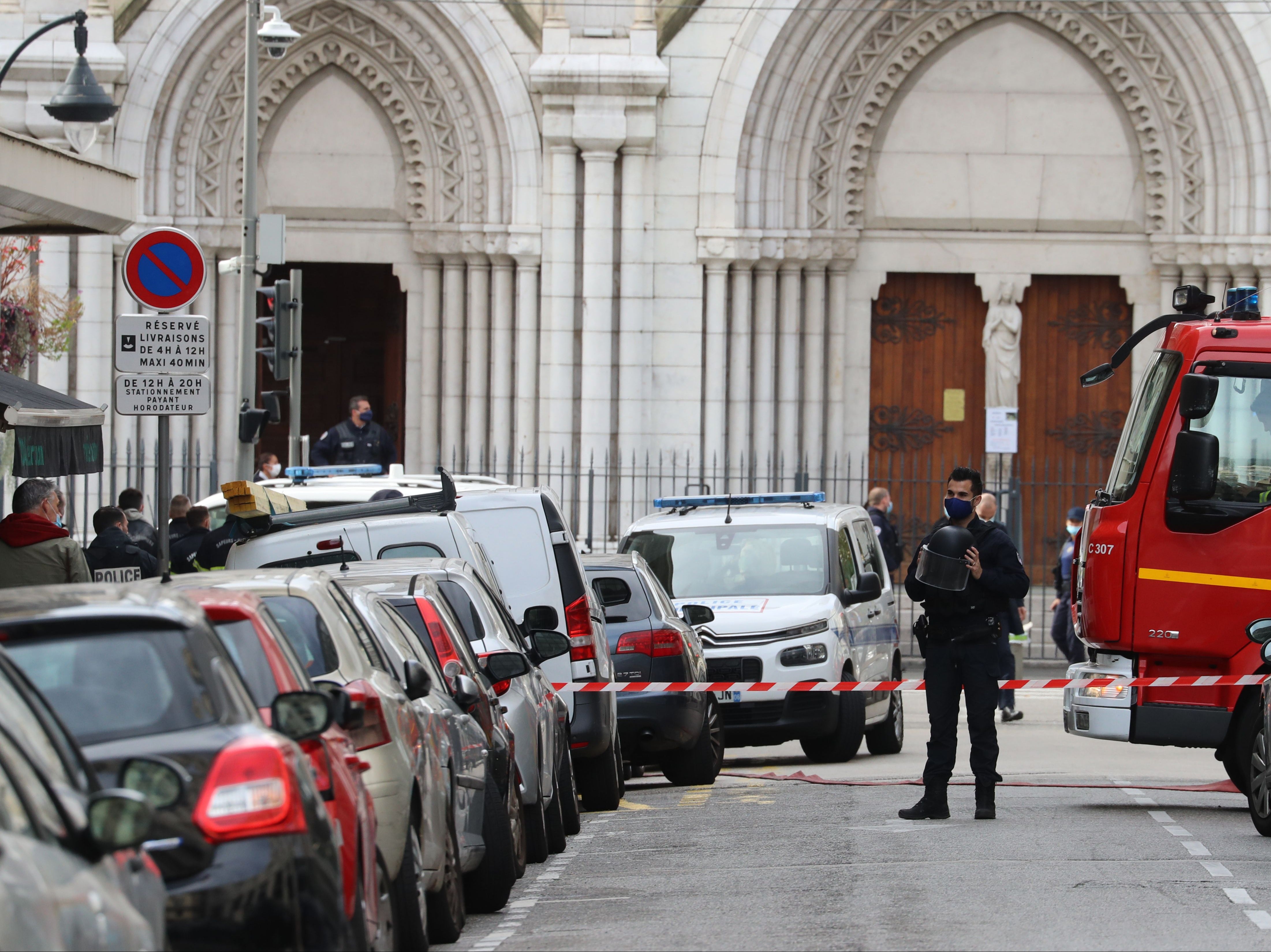 French policemen and firefighters secure the Basilica of Notre-Dame de Nice after a knife attack in Nice