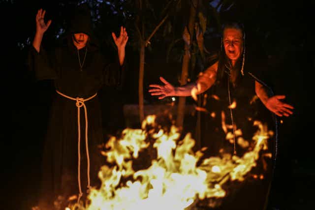 <p>Wiccan priestesses pray around a fire pit during the Imbolc, one of the eight Sabbat festivals, the most important dates in a witch’s calendar</p>