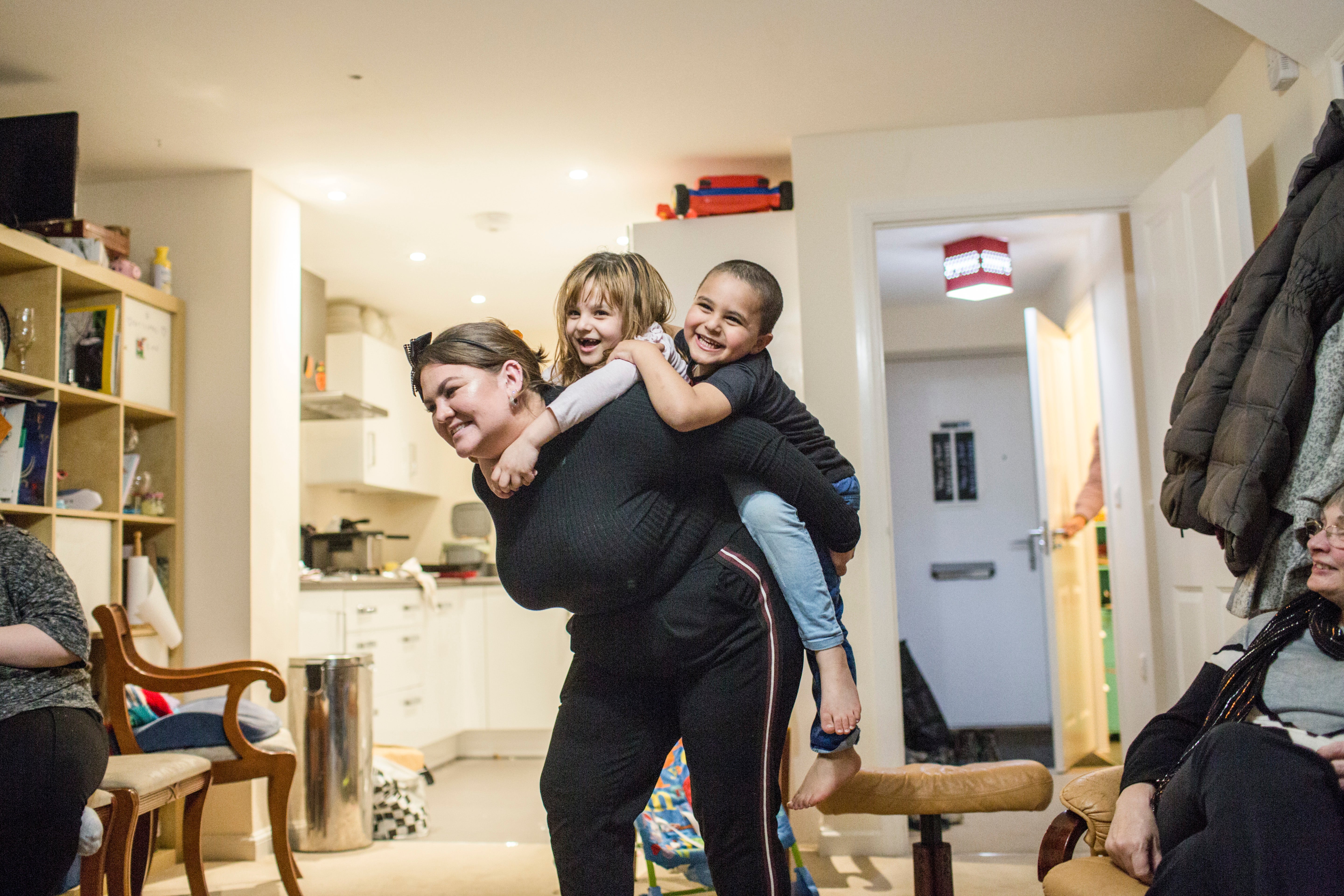 Amy Chapman plays with Adbul, 4, and Noor, 6, at the Arnout family home in Devon