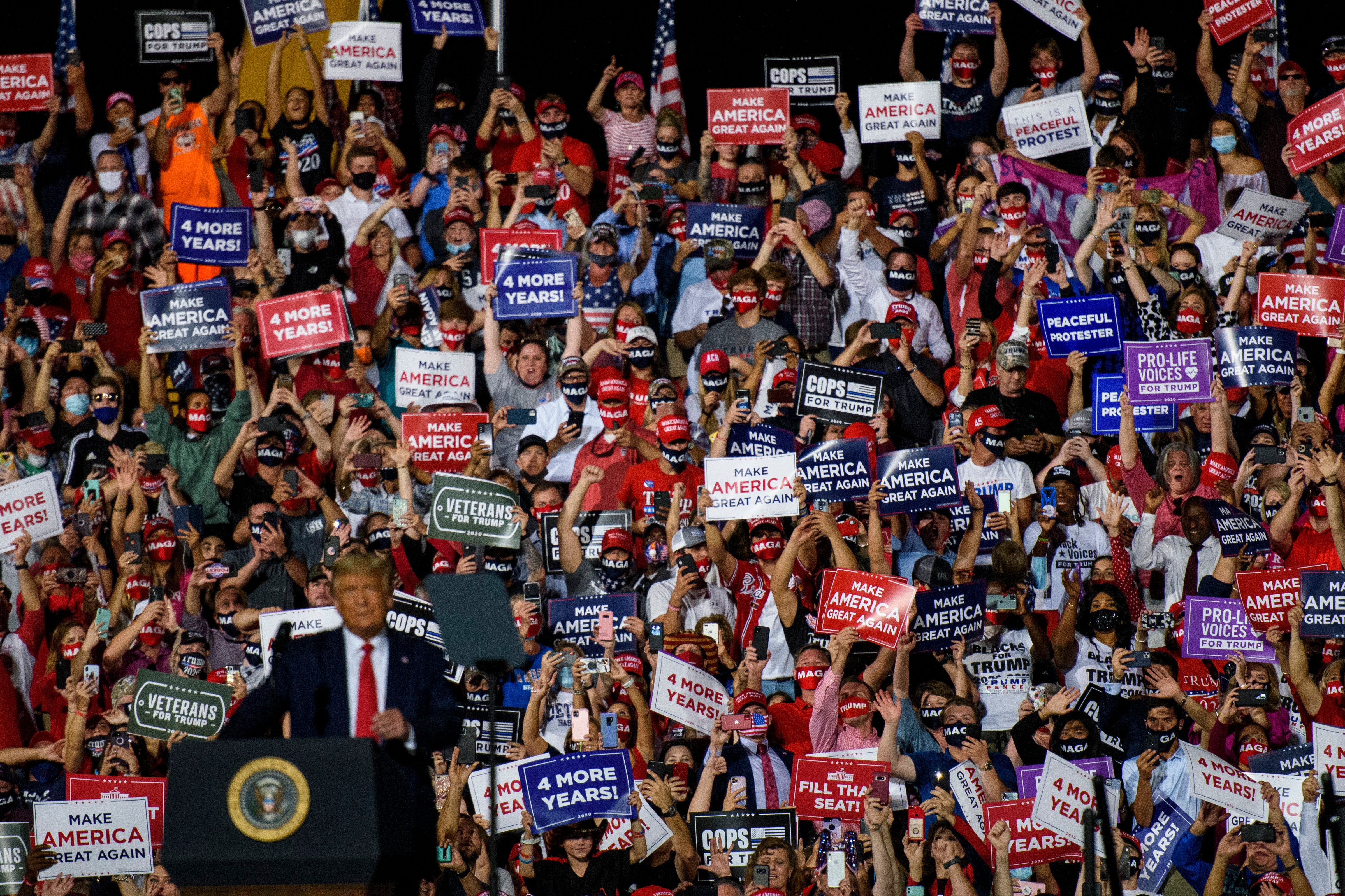 A crowd cheers for President Donald Trump as he arrives to make remarks during a rally at Gastonia Municipal Airport on October 21, 2020 in Gastonia, North Carolina. Polls in North Carolina show republicans not carrying the state 12 days before the election. (Photo by Melissa Sue Gerrits/Getty Images)