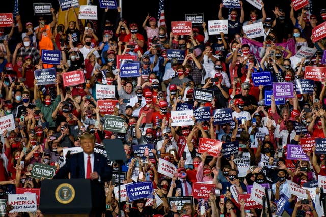 <p>A crowd cheers for President Donald Trump as he arrives to make remarks during a rally at Gastonia Municipal Airport in October</p>