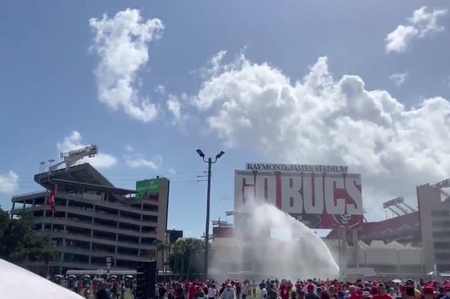 <p>Truck sprays water on the crowd as supporters wait in heat during Trump’s Tampa rally</p>