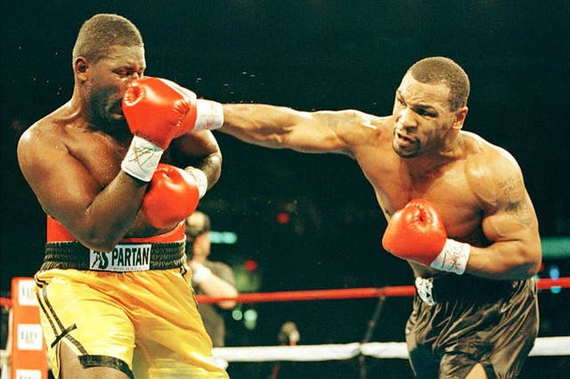<p>Mike Tyson lands a punch to Buster Mathis Jr in 1995</p>