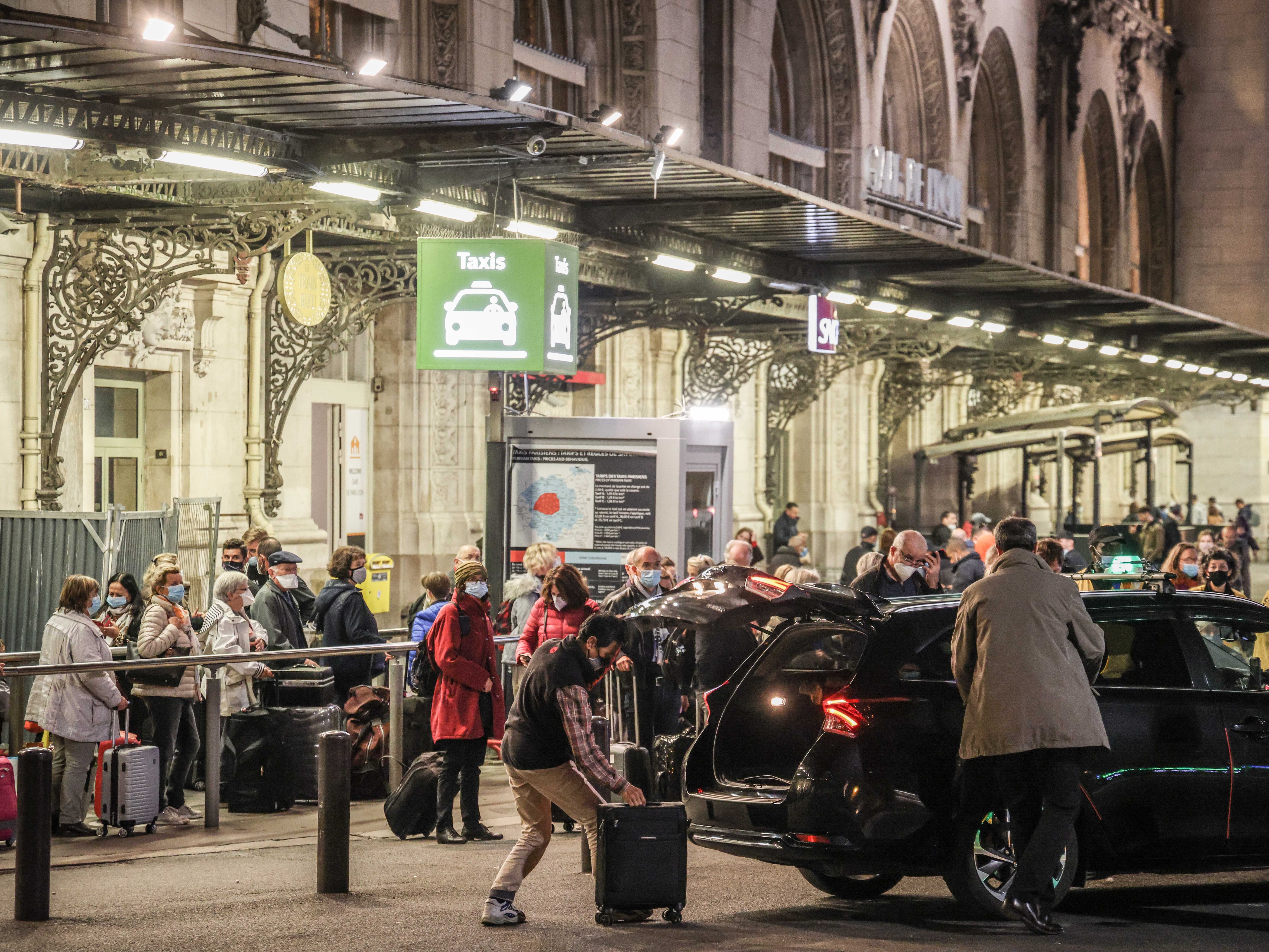 Parisians arrive at Gare de Lyon to join the growing queues of people attempting to get inside and on a train