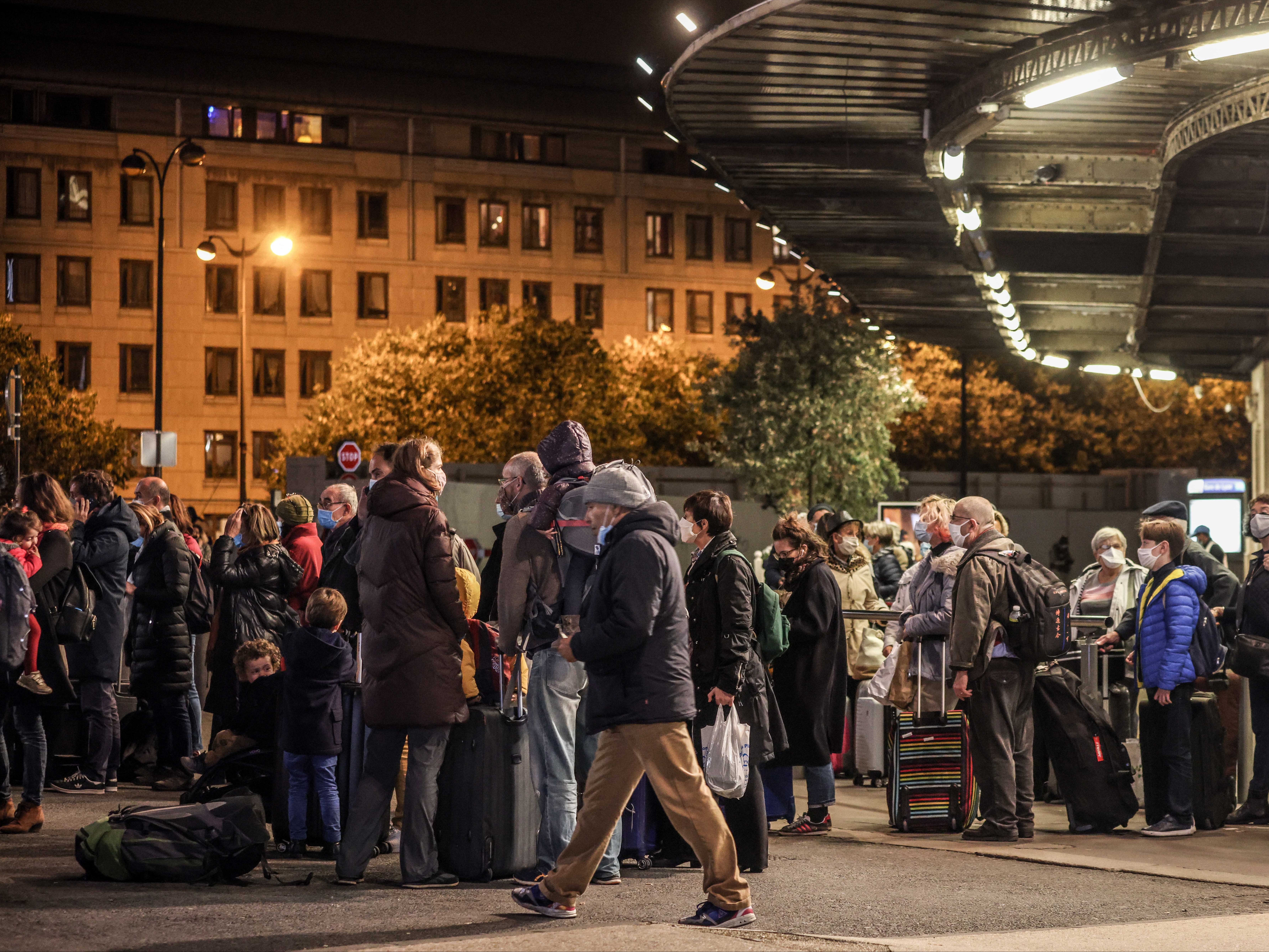 Crowds gather outside Gare de Lyon as residents attempt to avoid being locked down in the capital